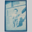 Baby standing outside barracks (ddr-densho-329-1333)