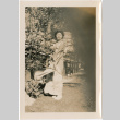 Tomoye (Nozawa) Takahashi in kimono standing in garden (ddr-densho-426-1867)