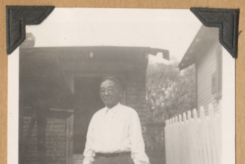 Man standing on a sidewalk (ddr-densho-542-212)