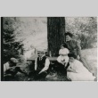 Family gathered outside under tree with a photographer (ddr-densho-353-213)