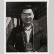Man holding a camera (ddr-densho-542-794)