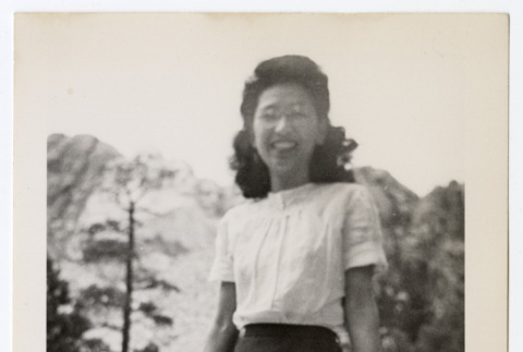 Smiling woman at the foot of a mountain (ddr-densho-404-427)