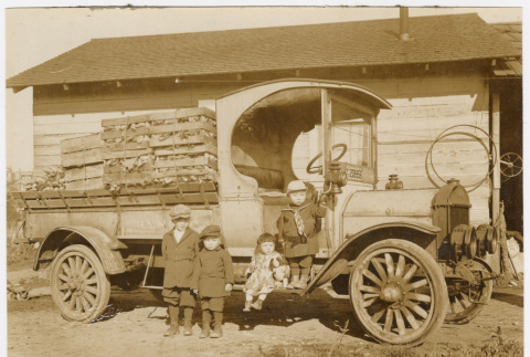 Four children posed by truck (ddr-densho-540-19)