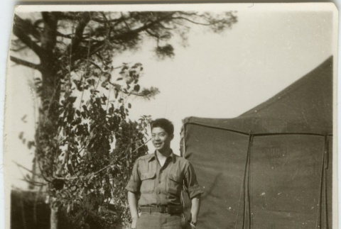 Japanese American soldier outside tent (ddr-densho-201-158)