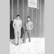 Two young men outside a barrack (ddr-densho-102-19)