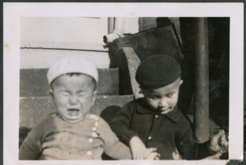 Two boy sitting on stoop, one crying (ddr-densho-483-539)