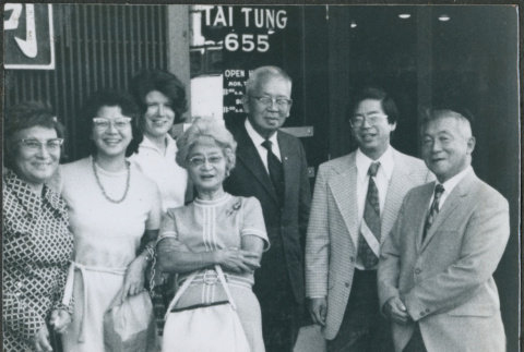 Seven people outside Tai Tungs (ddr-densho-523-657)