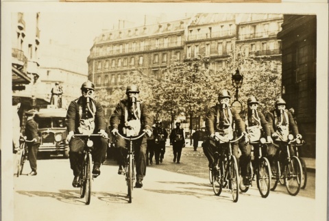 Men in gas masks riding bicycles (ddr-njpa-13-1329)