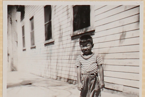 Boy standing on sidewalk (ddr-densho-522-9)