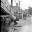 Man unloading lumber from truck (ddr-densho-426-2170)