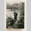Two people on riverbank, one pointing (ddr-densho-377-1767)