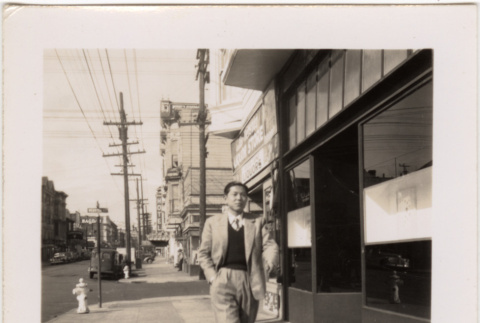 Man walking down street (ddr-densho-426-26)