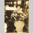 A woman holding flowers (ddr-njpa-4-2833)