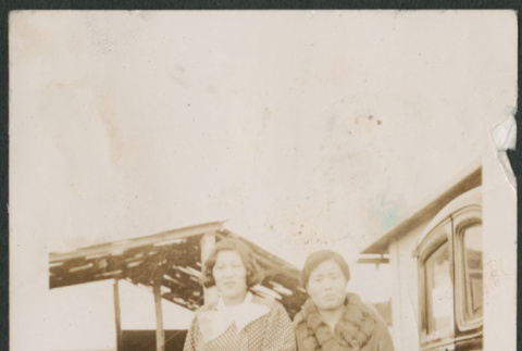 Two women and a dog by car (ddr-densho-316-197)