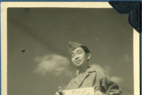 Soldier holding his Coca Cola ration (ddr-densho-22-22)