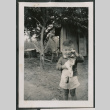 Photo of Kenji Ima holding a cat (ddr-densho-483-855)