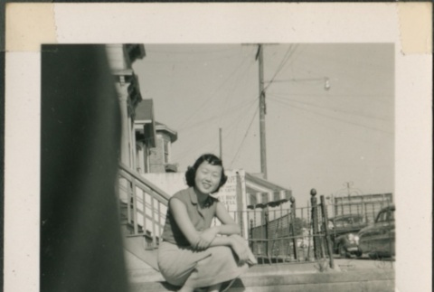 Woman sitting on a curb (ddr-densho-321-112)