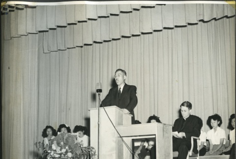 Rev. Shinjo Nagatomi speaking at graduation (ddr-manz-4-227)