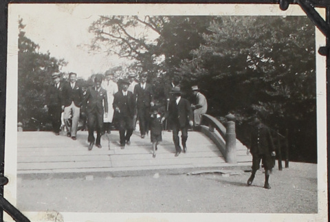 Men walking across small bridge (ddr-densho-326-139)