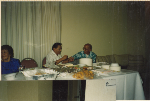 Two men sitting at a table talking (ddr-densho-466-501)