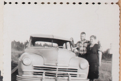Film strip photo of a couple with a car (ddr-densho-483-438)