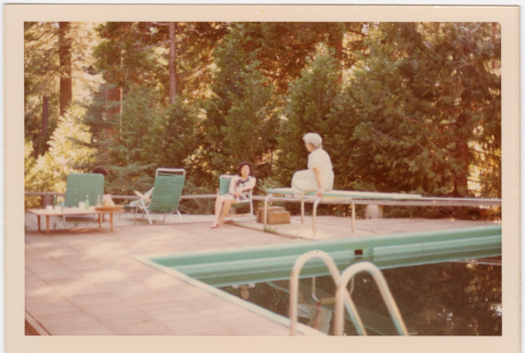 Tomoye Takahashi and unknown woman seated by swimming pool (ddr-densho-426-1107)