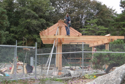 Carpenter Dave Schmidt dressing beams on overlook structure (ddr-densho-354-2287)