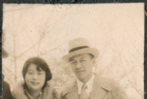 Couple standing on sidewalk in snow (ddr-densho-523-32)