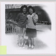 Two women standing outside (ddr-manz-10-140)