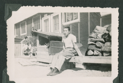 Man sitting on a bench (ddr-densho-471-51)