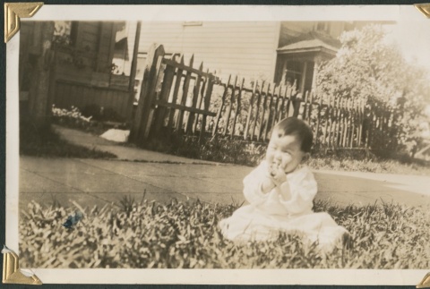 A baby in front of a house (ddr-densho-321-742)
