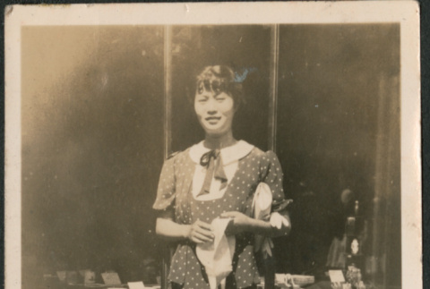 Woman standing outside shop (ddr-densho-523-48)