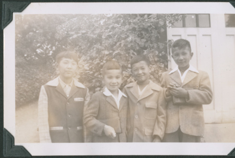 Photo of four children in sports jackets (ddr-densho-483-1211)
