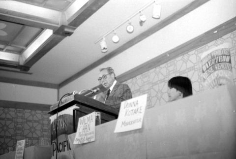 Stanley Diamond speaking, Wilma Chan at table (ddr-densho-1007-540)