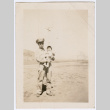 Man in uniform holding child (ddr-densho-316-109)