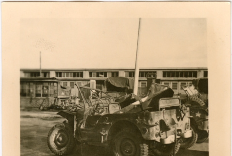 Damaged jeep outside barracks (ddr-densho-458-49)