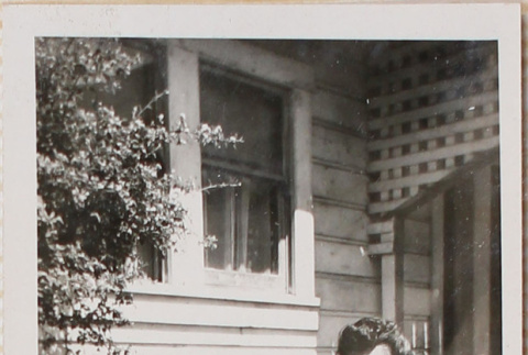 Woman holding baby sitting outside house (ddr-densho-464-133)