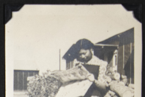 Alice Kikawa reading a newspaper (ddr-densho-542-609)
