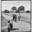 Family walking to barracks (ddr-densho-151-284)