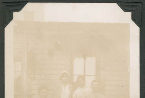 Photo of a family of five on a front porch (ddr-densho-483-181)