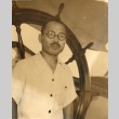 Man posing at a ship's helm (ddr-njpa-4-2182)