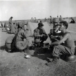 Group of soldiers drinking in field of tents (ddr-densho-474-242)