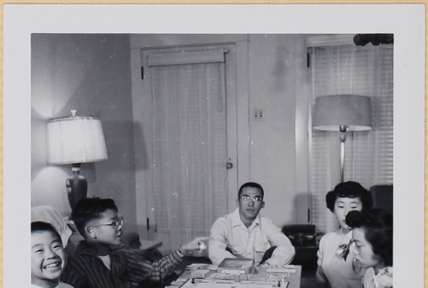 Group playing Monopoly (ddr-densho-522-554)