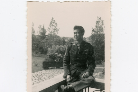 Saburo Arthur Kitagawa sitting on railing (ddr-densho-539-27)