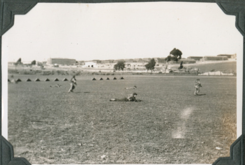 Men in field with fort in background (ddr-ajah-2-56)