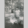 Agnes Sakura and boy sitting on lawn (ddr-densho-523-217)