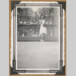 Martha Ito poses next to a trophy case (ddr-densho-542-52)