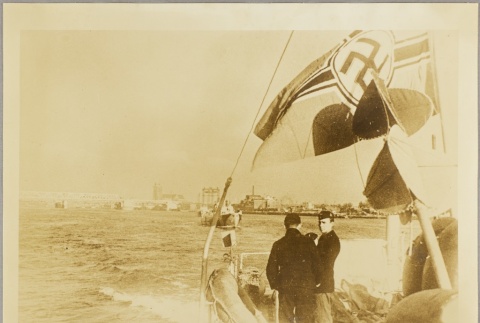 Sailors standing under a Nazi flag on board ship (ddr-njpa-13-983)