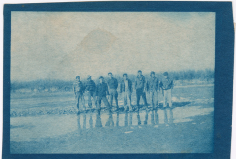 Eight men standing in muddy field (ddr-densho-329-1375)