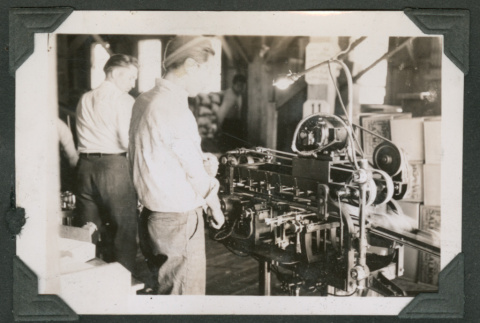 Men working labeling machine at cannery (ddr-densho-540-80)